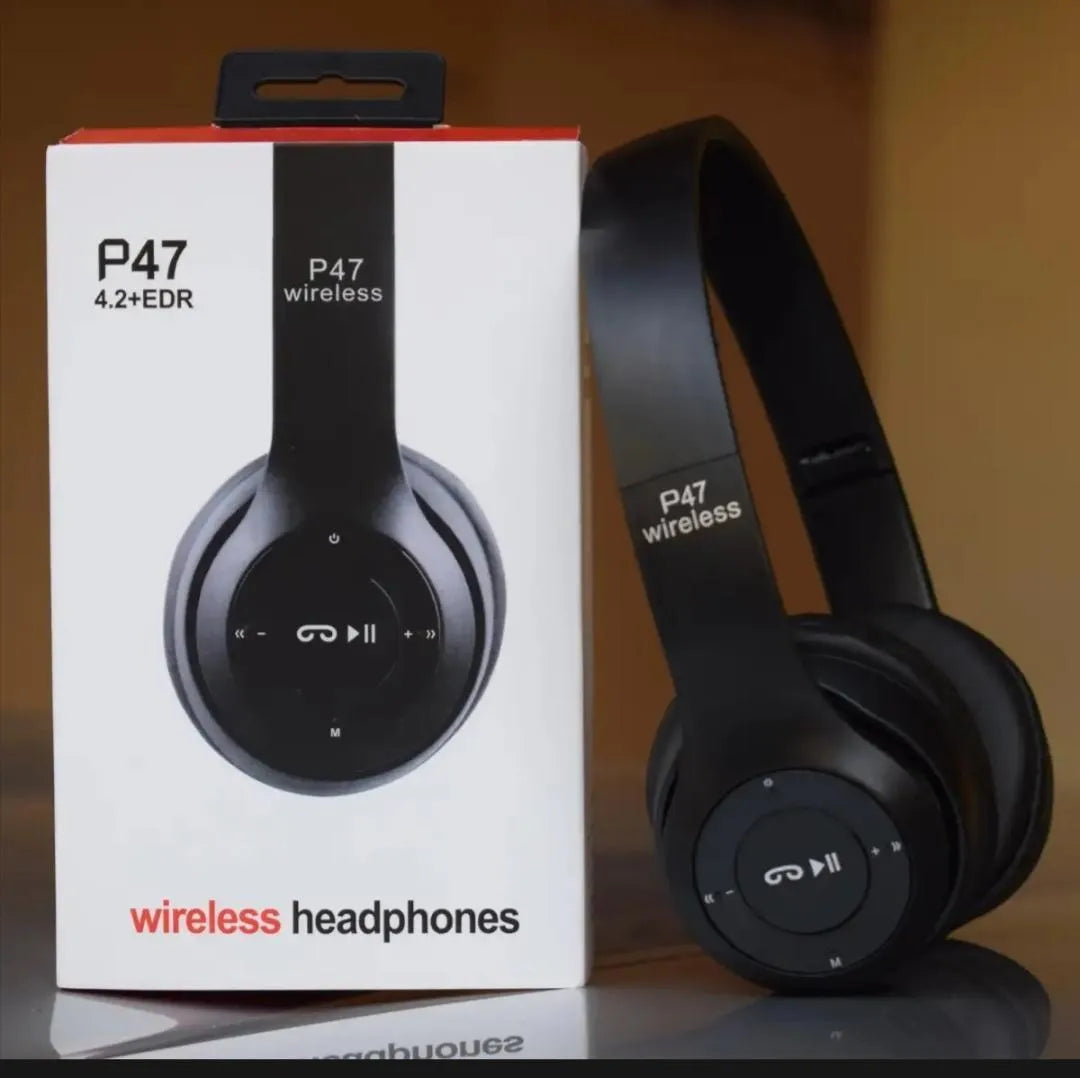 Black wireless headphones next to their packaging box labeled P47 on a reflective surface.