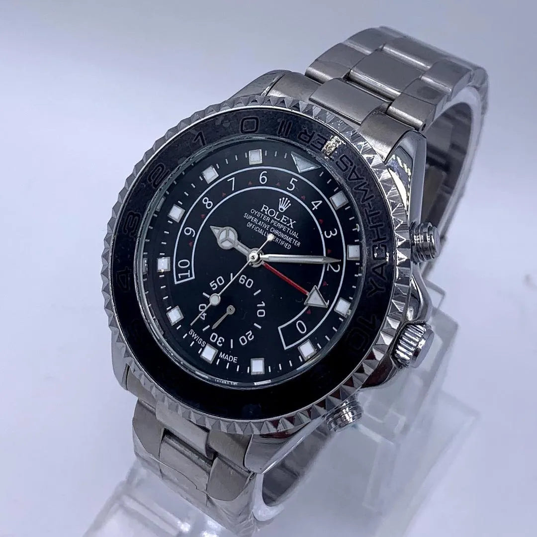 Silver watch with black dial on a light gray background